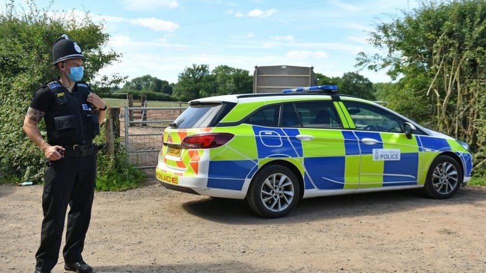 Police officer outside the farm