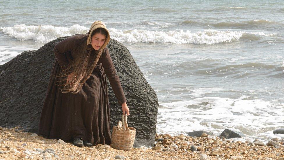 Katy Hamilton in costume as Mary Anning on the beach