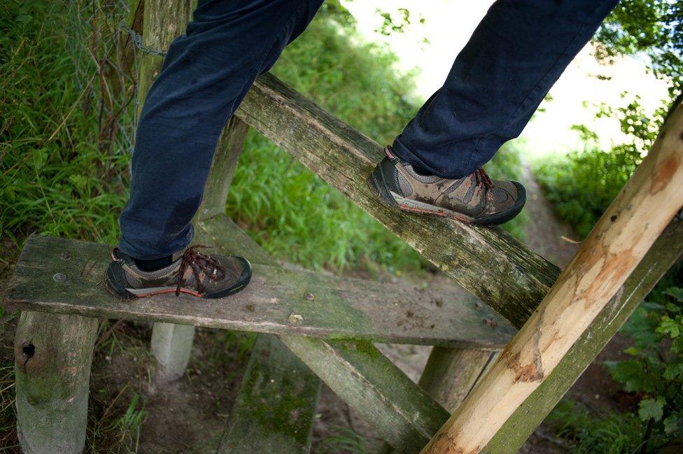 Man walking over stile