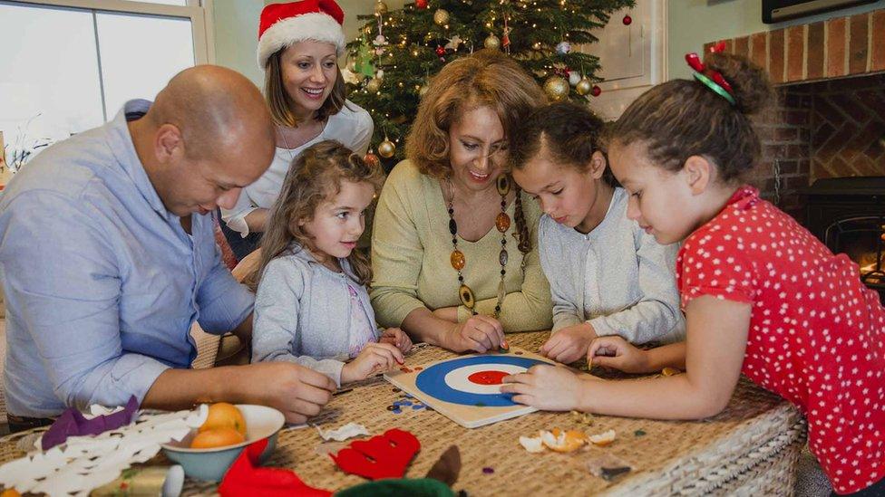 Family playing a Christmas board game