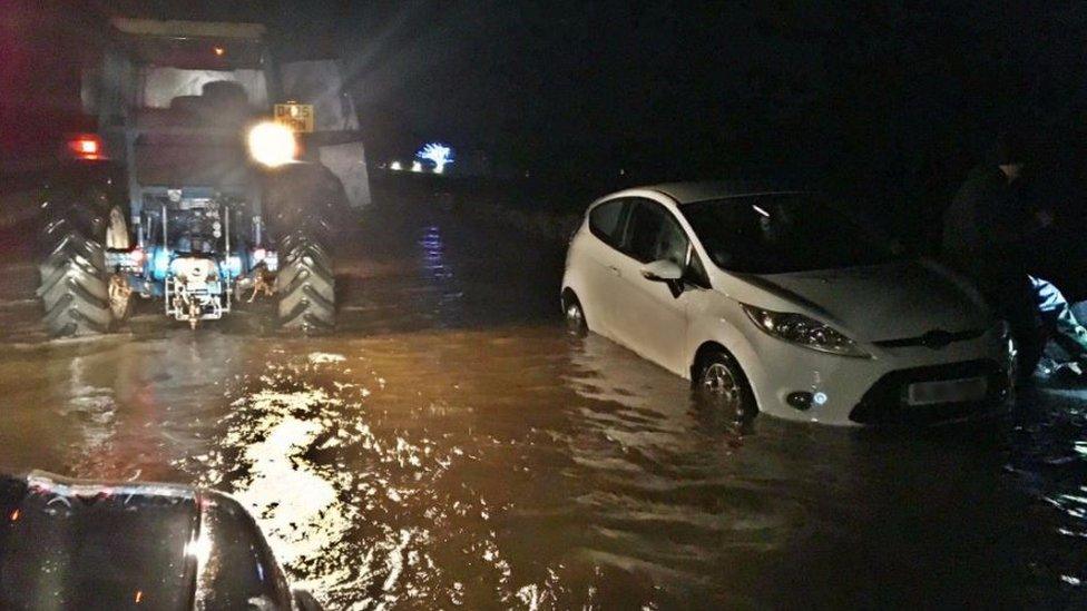 Car in flood water on A65