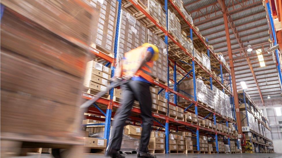 Warehouse worker moving boxes