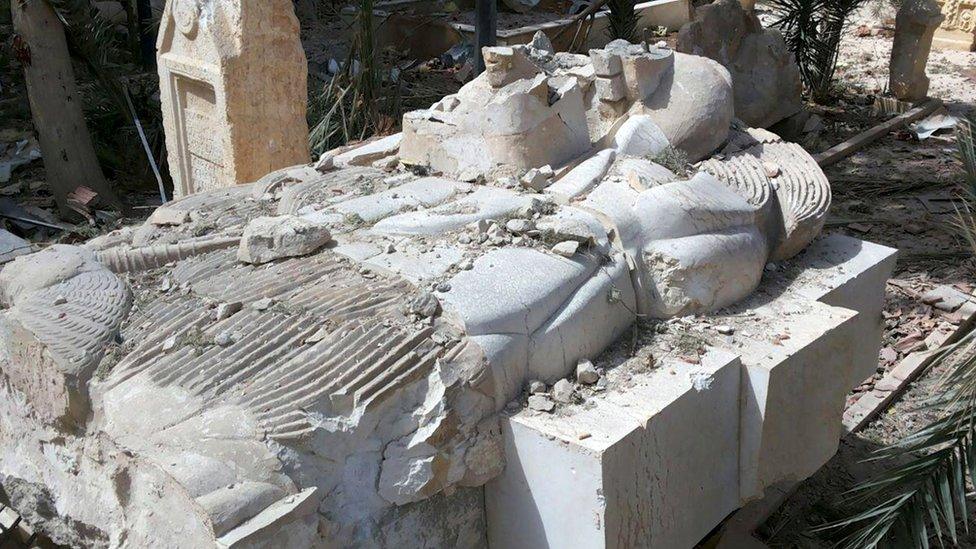 A view shows a damaged artefact at the entrance of the museum of the historic city of Palmyra, after forces loyal to Syria"s President Bashar al-Assad recaptured the city