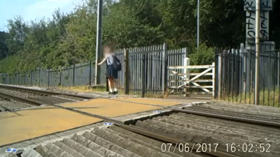 Child playing on railway tracks