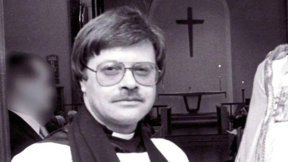 A black and white photograph of the late Reverend Trevor Devamanikkam