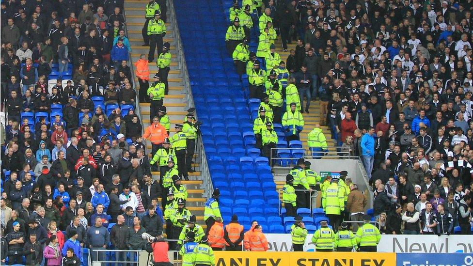 fans kept apart by police