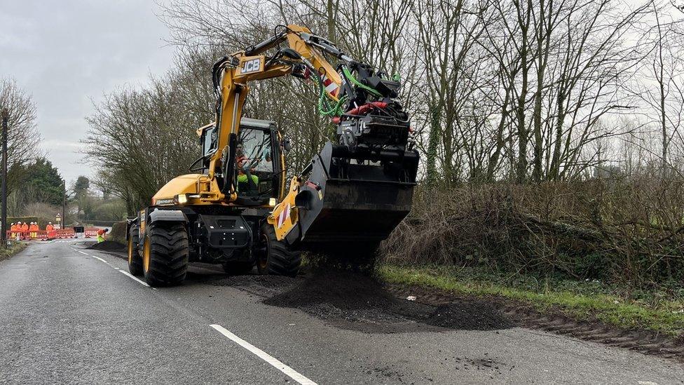 JCB machine fixing pothole