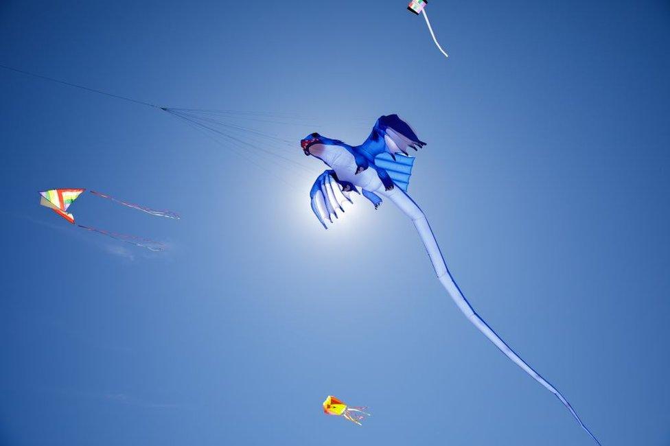 People fly kites at the Dolphin Beach in Cape Town, South Africa.