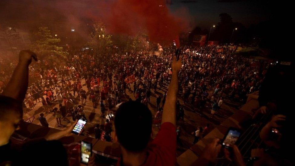 Fans celebrate Liverpool winning the Premier League title