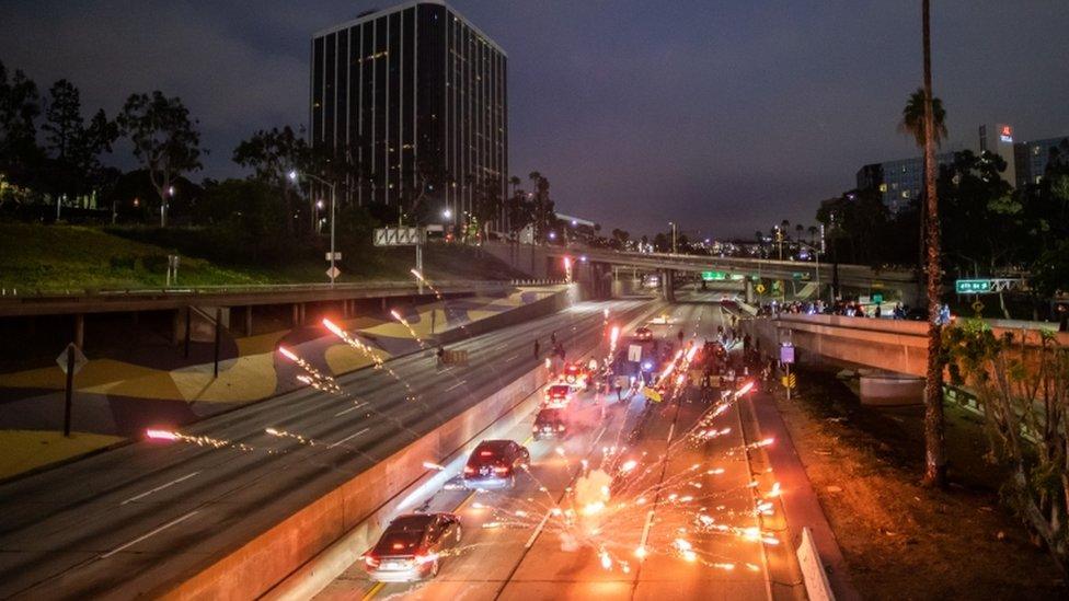 Fireworks were thrown on to Freeway 110 North, in Los Angeles, as protesters tried to block roads