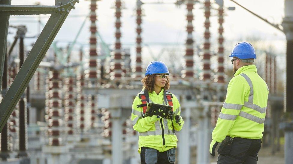 Workers at electricity substation