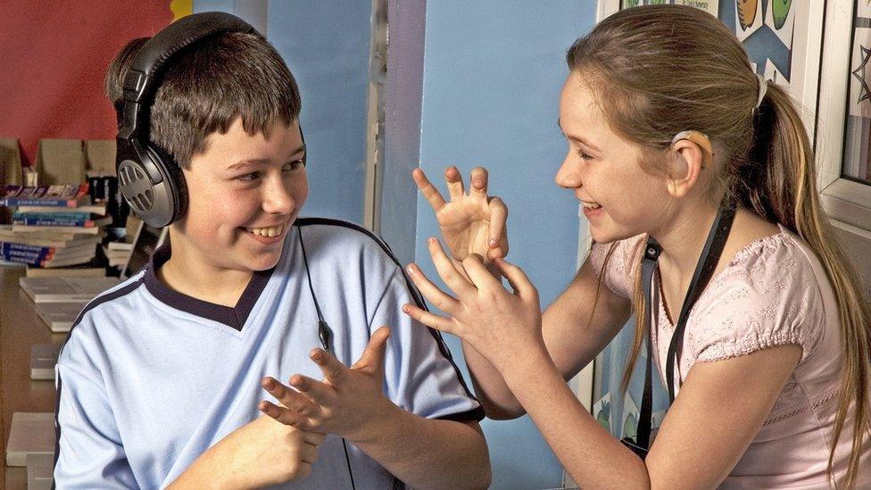 children signing to each other