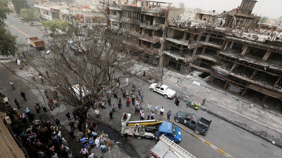 People gather at the site of a suicide bombing in Baghdad's Karrada district (4 July 2016)