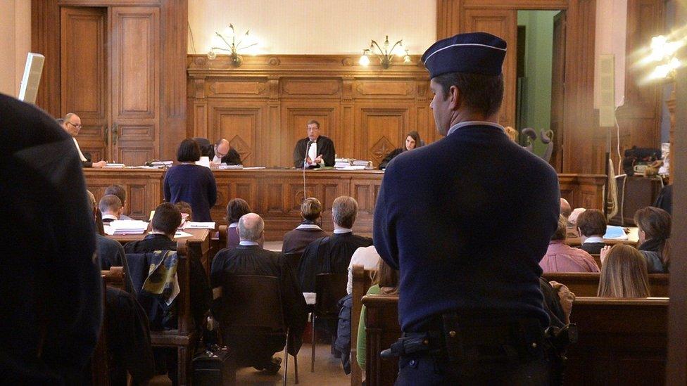 People attend the trial against members of the Church of Scientology in Belgium