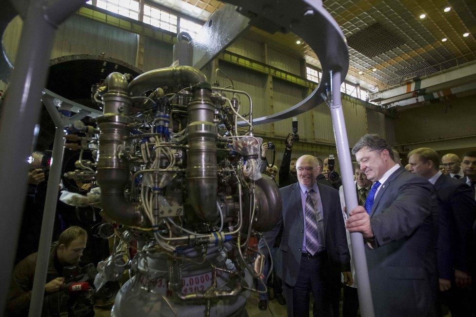 Ukraines President Petro Poroshenko (R, front) listens to explanations as he visits the factory Yuzhmash in Dnipro (Dnipropetrovsk), Ukraine, 21 October 2014