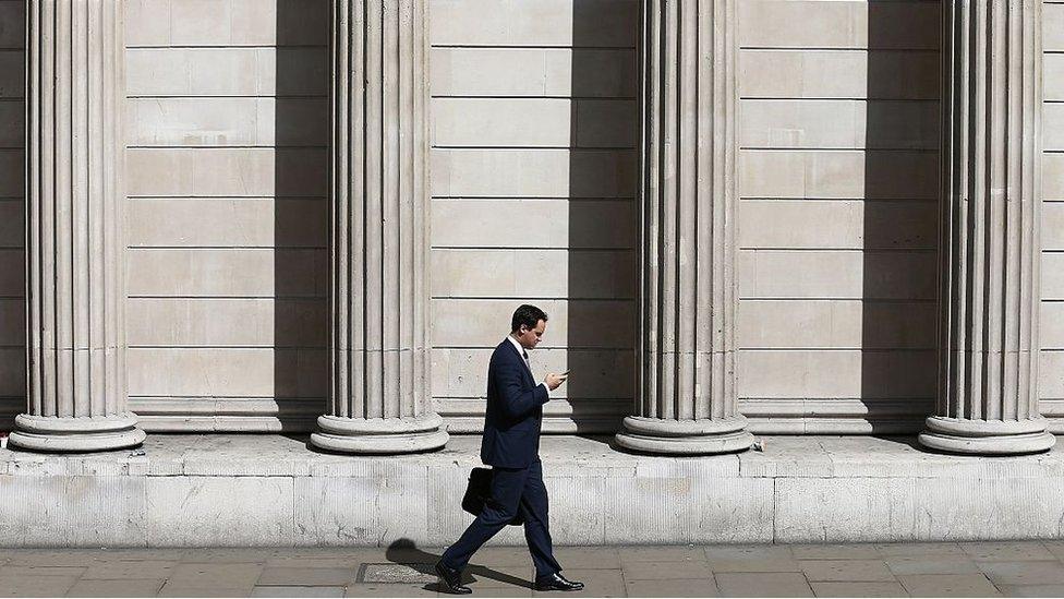 A man walks past the the Bank of England