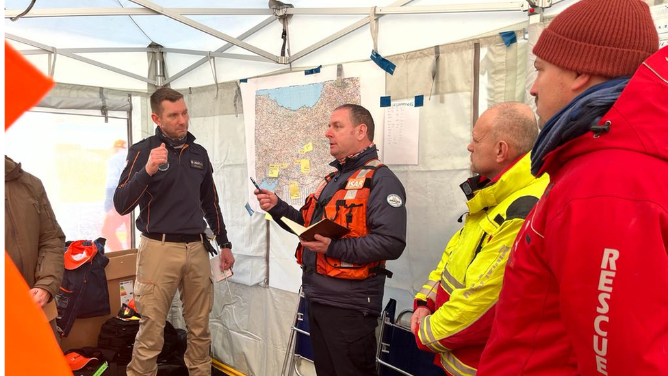 David O'Neill talking to a team of firefighters