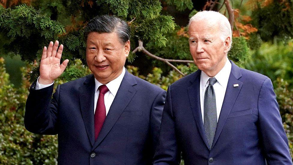 Chinese President Xi Jinping waves as he walks with US President Joe Biden at Filoli estate on the sidelines of the Asia-Pacific Economic Cooperation (APEC) summit, in Woodside, California, US, on 15 November 2023