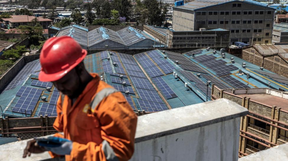 A technician from CP Solar works on the installation of solar panels at the roof a partially solar-powered factory in the industrial area of Nairobi. Renewable energy sources generate over 80% of Kenya's electricity