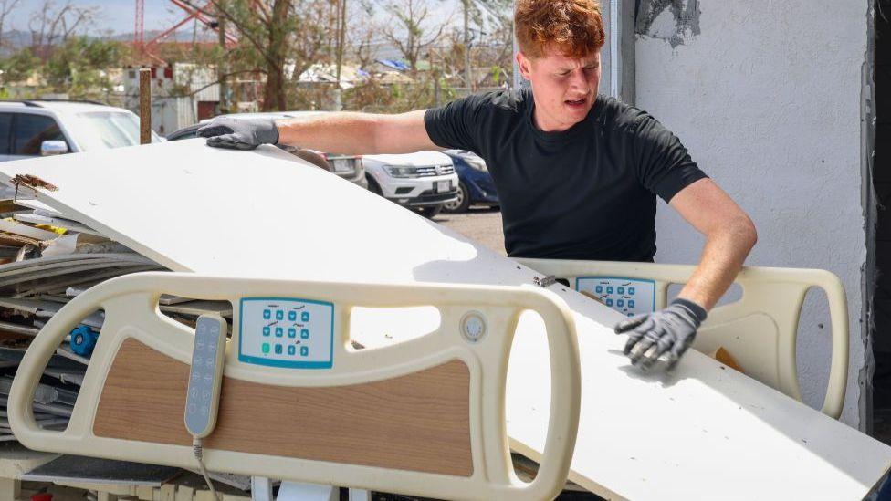 Man putting debris on hospital bed