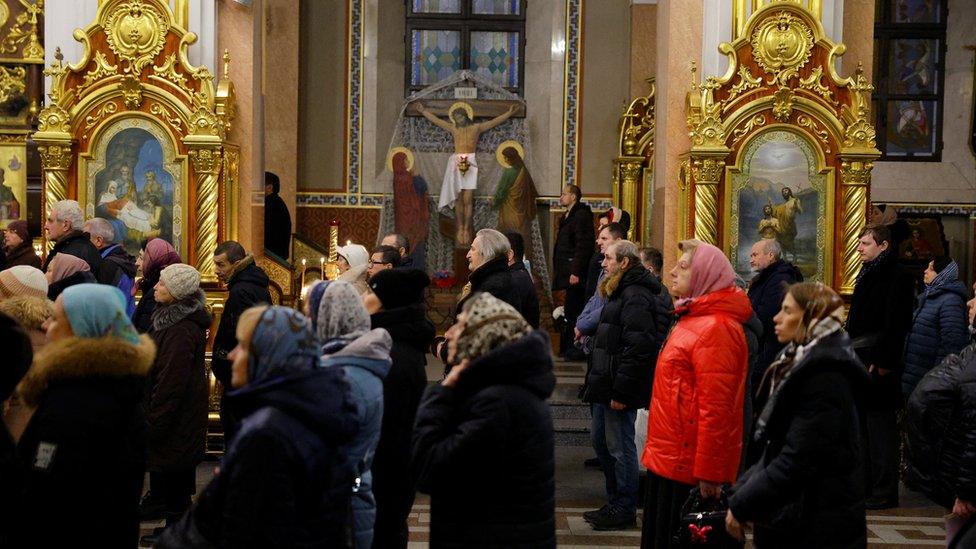 Dozens of people in a cathedral in Donetsk on Christmas Eve for Orthodox Christmas