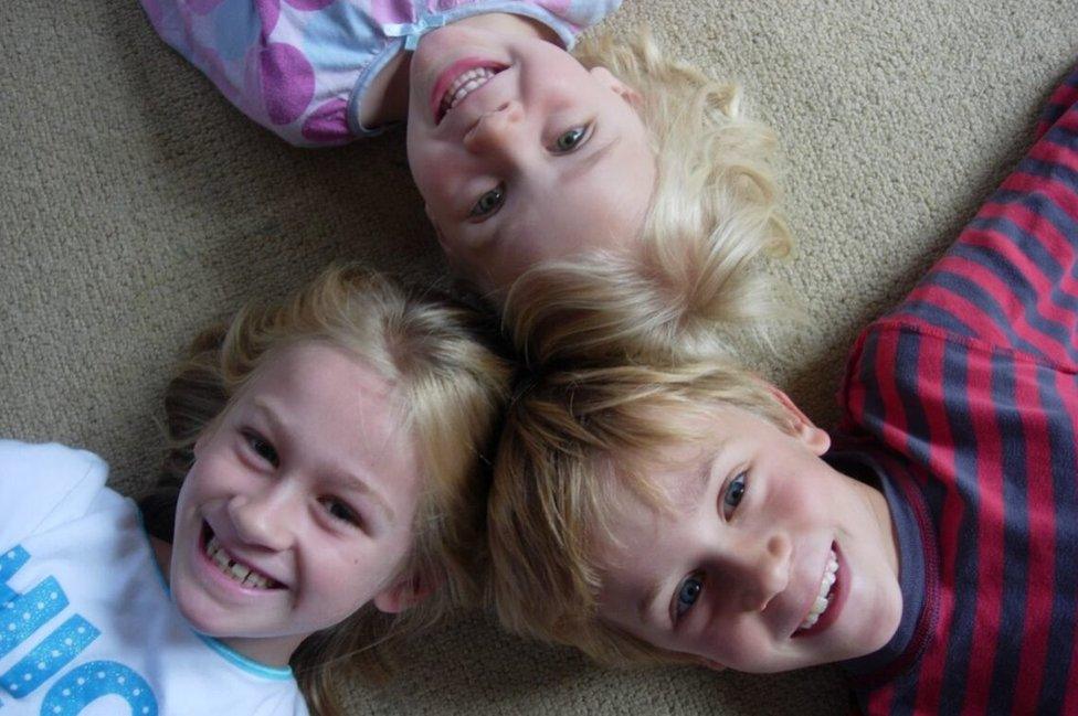 Tom, pictured with his sisters Maddy and Evie