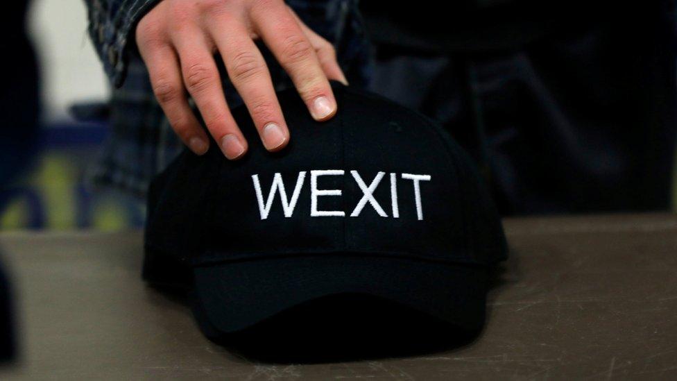 A supporter holds his Wexit hat at a rally for Wexit Alberta, a separatist group Alberta independence