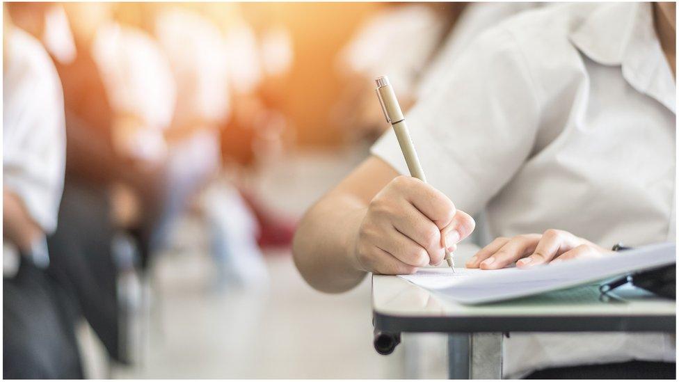 A school child with pencil and notebook