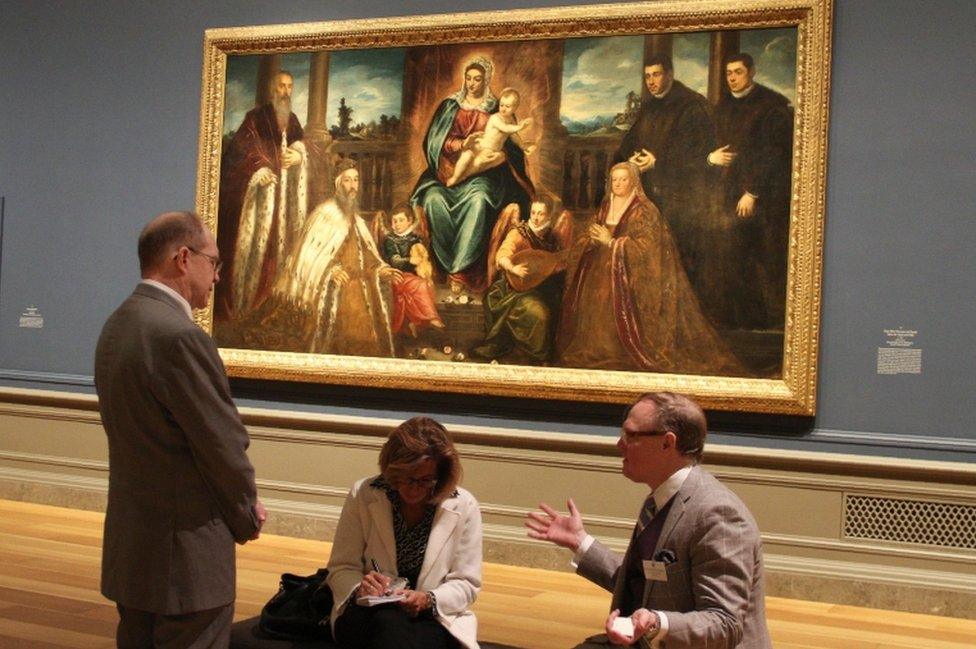 Exhibition co-curators Frederick Ilchman (R) and Robert Echols (L) speak with a visitor in front of Jacopo Tintoretto"s "Doge Alvise Mocenigo and Family before the Virgin and Child"