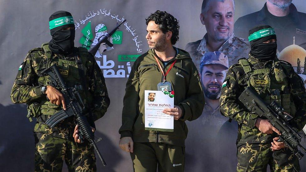 Ofer Kalderon, wearing a green shirt, stood on a stage beside Hamas soldiers as he is released from Gaza