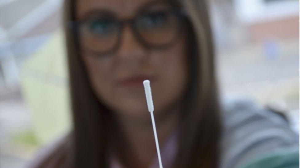 Woman holding lateral flow test