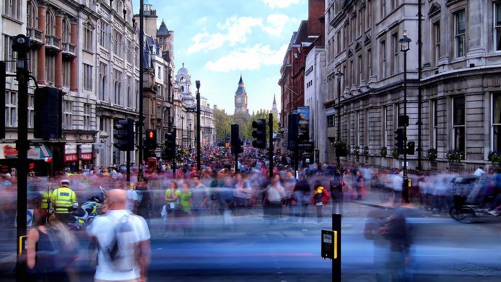 Long exposure showing crowds walking on Whitehall