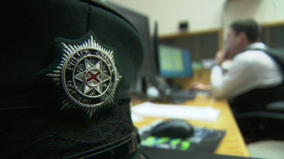 Police officer sitting at desk