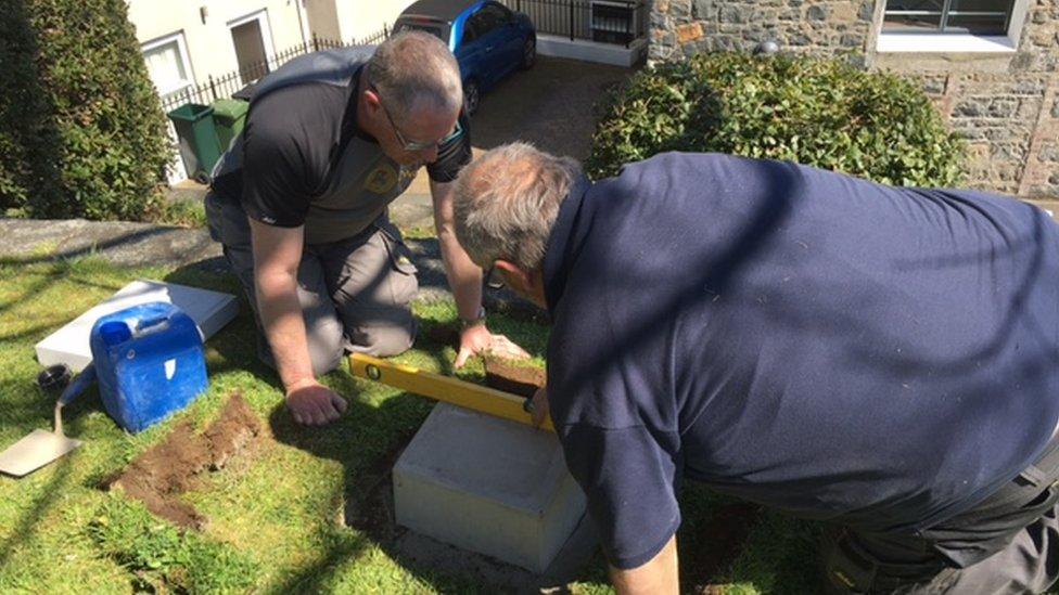 Men measuring stone