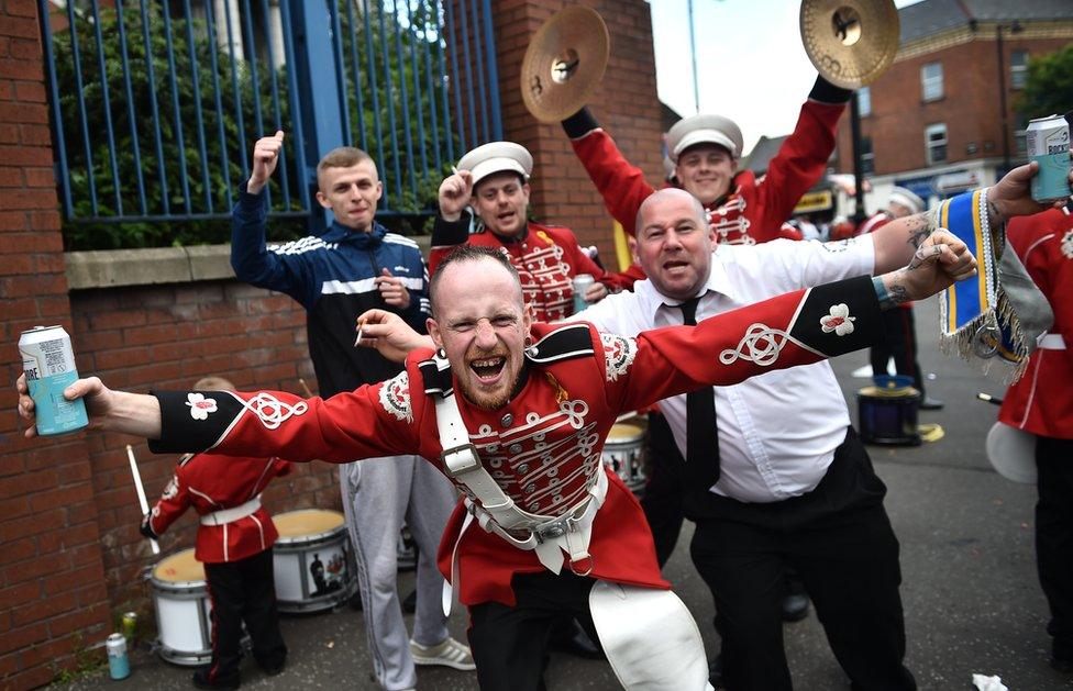 Members of a marching band pose for a photograph