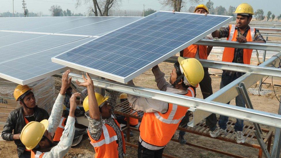 Indian workers construct part of the France-India Solar Direct Punjab Solar Park project in Muradwala