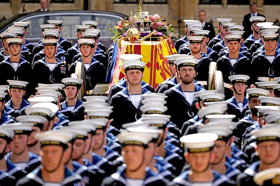 The coffin of Queen Elizabeth II with the Imperial State Crown resting on top, borne on the State Gun Carriage of the Royal Navy departs Westminster Abbey on September 19, 2022 in London