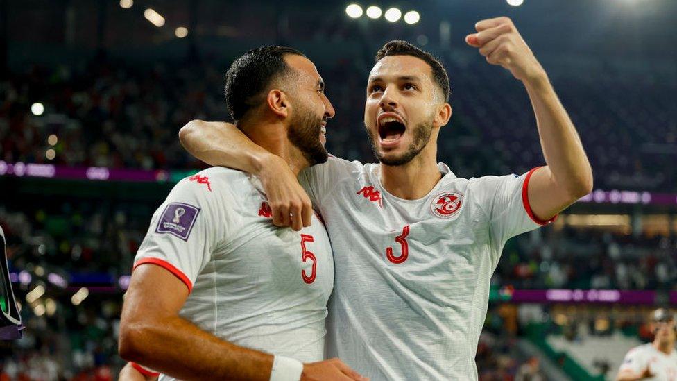 Tunisia players celebrating after scoring an offside goal