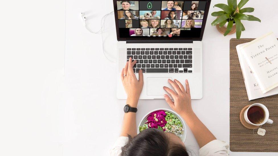 A woman having a 'Zoom lunch' with colleagues