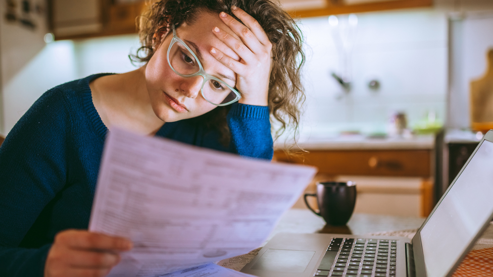 Woman looking at bills