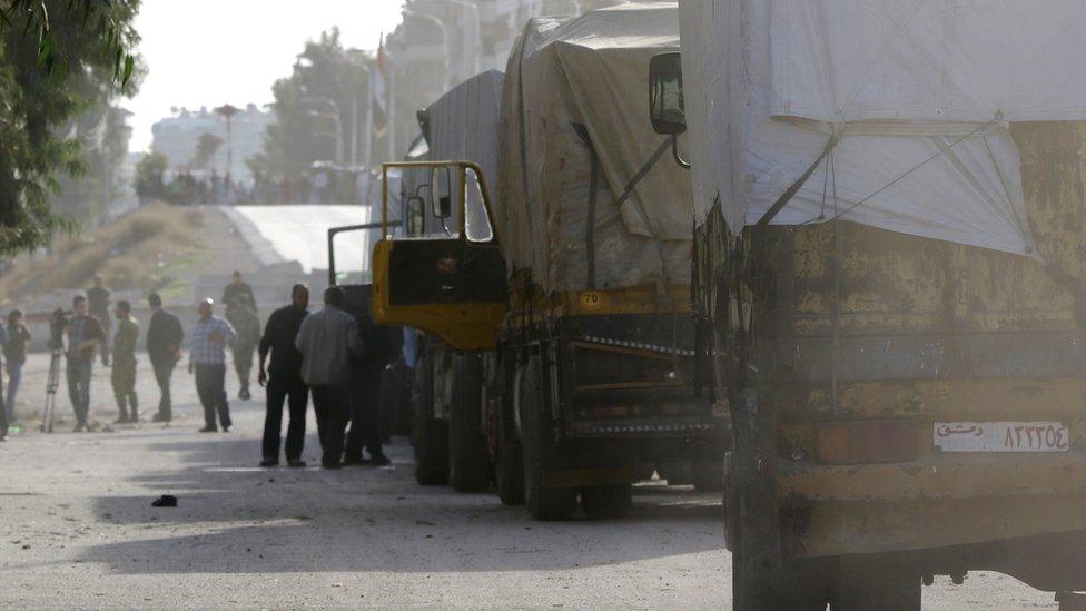 UNHCR aid convoys prepare to enter Moadimayet al-Sham, a rebel-held town near the Syrian capital Damascus.