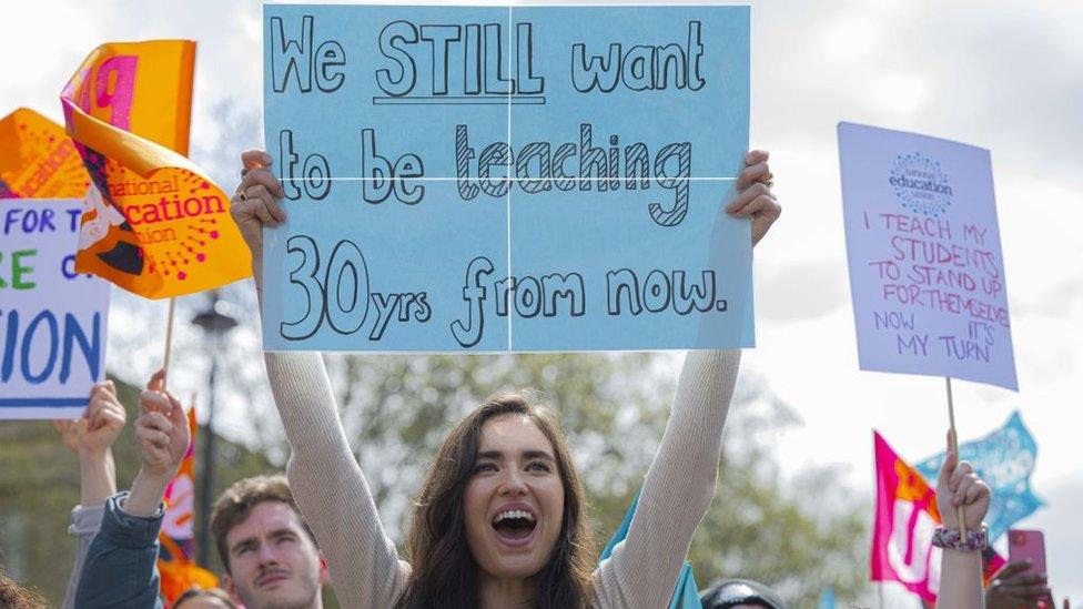 Teachers on strike holding placards