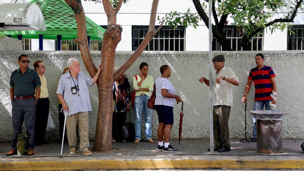 People at a bus stop in San Juan Puerto Rico