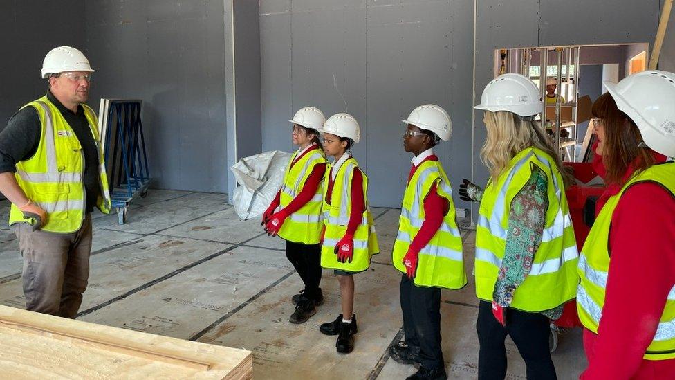 Children looking around the new school building