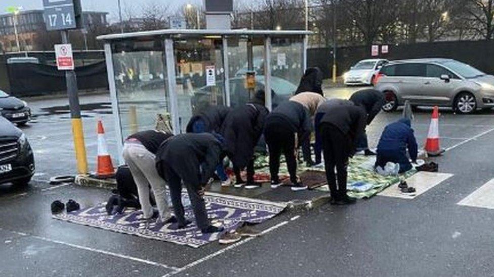 Drivers praying at bus stop