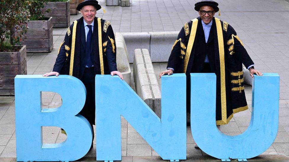 Professor Nick Braisby and Jay Blades in front of a BNU sign