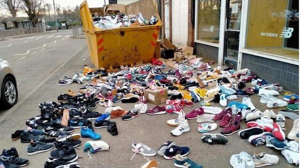 Trainers strewn across the group outside the New Balance shop in Shap