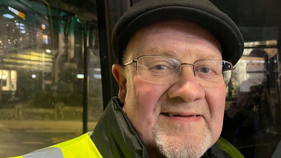 Barry Waterson standing next to a bus