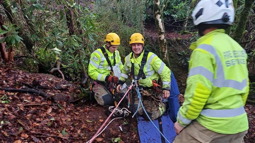 The firefighters with system of ropes