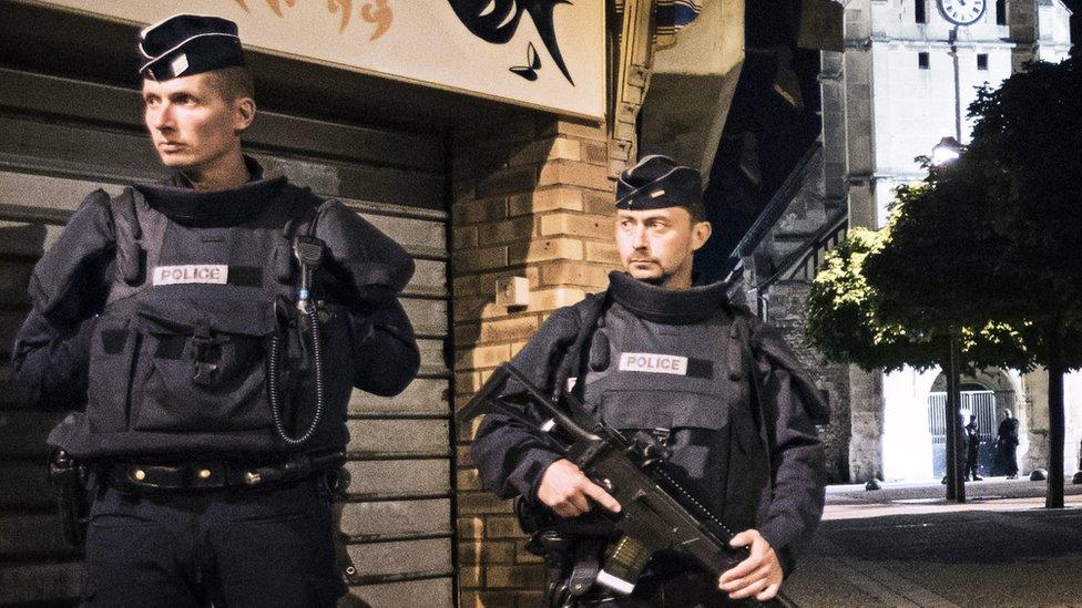 French police stand guard at the scene of a stabbing by Islamist militants near Rouen